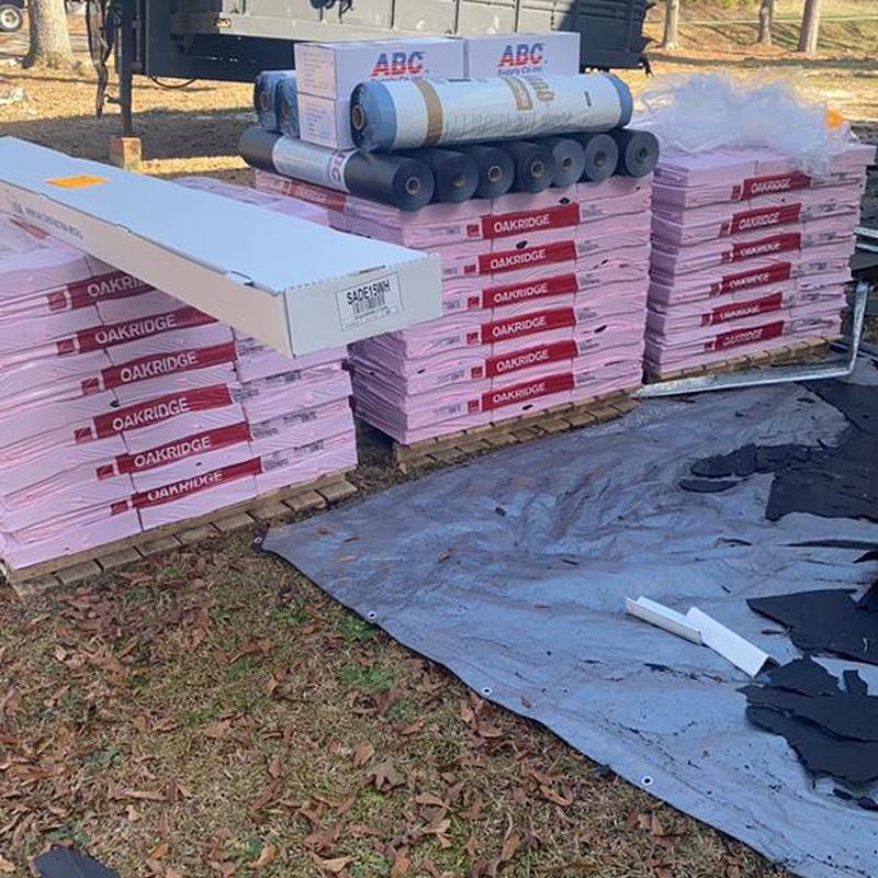 Roofing shingles and underlayment stacked on pallets outdoors Roofing shingles and underlayment stacked on pallets outdoors