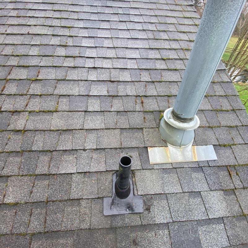 Pipe flashing and roof vent on asphalt shingle roof