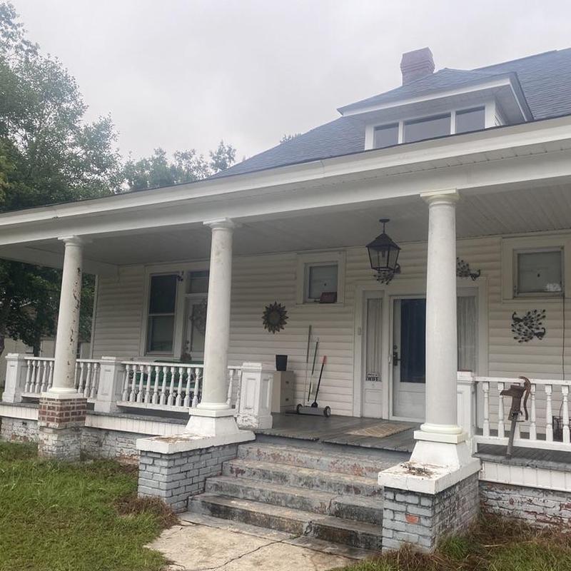 Front porch columns and railings with brick base