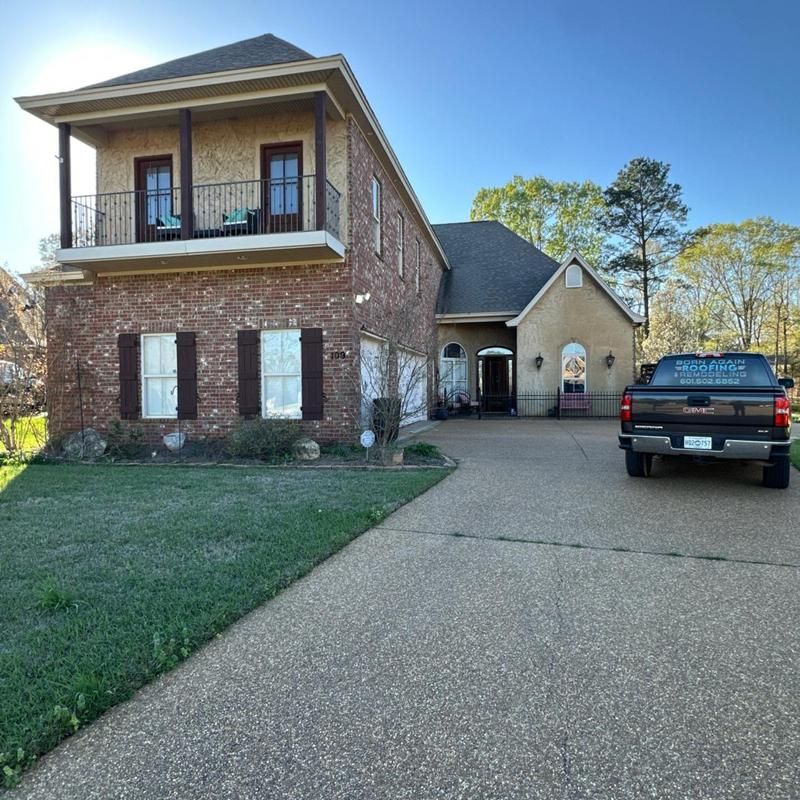 Asphalt shingle roof on residential house with truck
