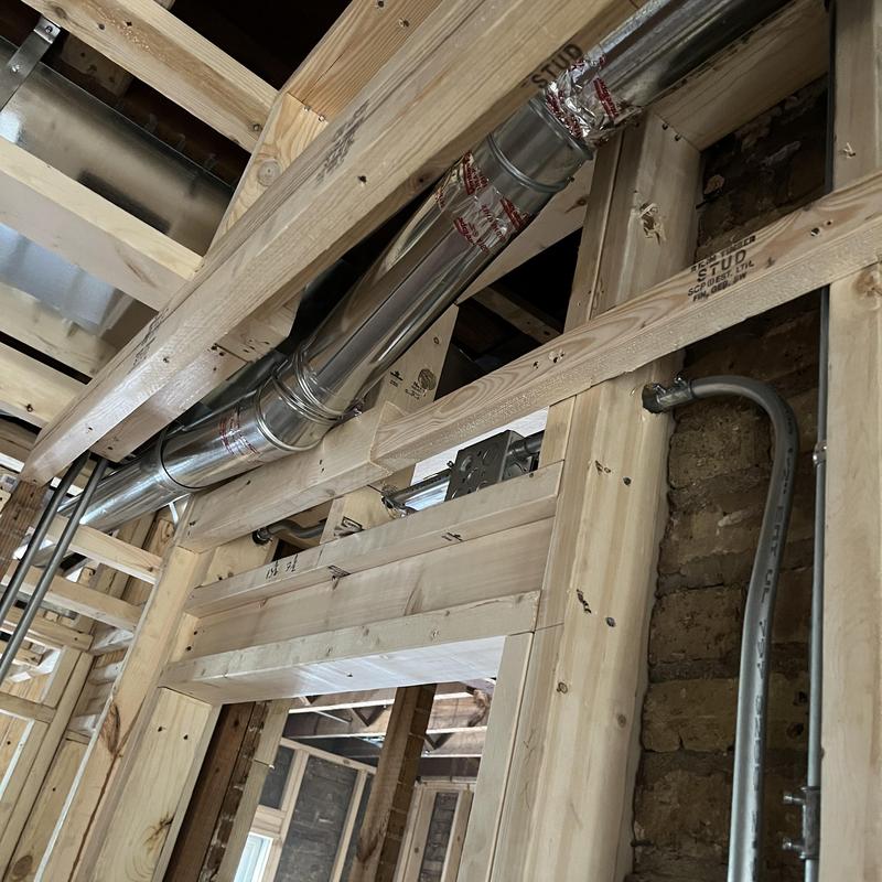 Dryer vent exhaust duct installed in wooden framing