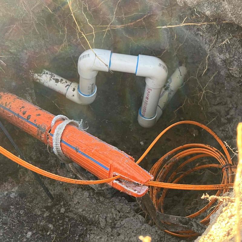 PVC underground piping with orange conduit and cables PVC underground piping with orange conduit and cables