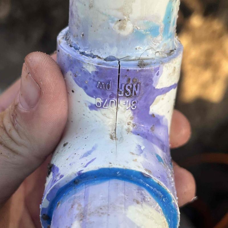 Cracked underground PVC plumbing pipe close-up repair Cracked underground PVC plumbing pipe close-up repair