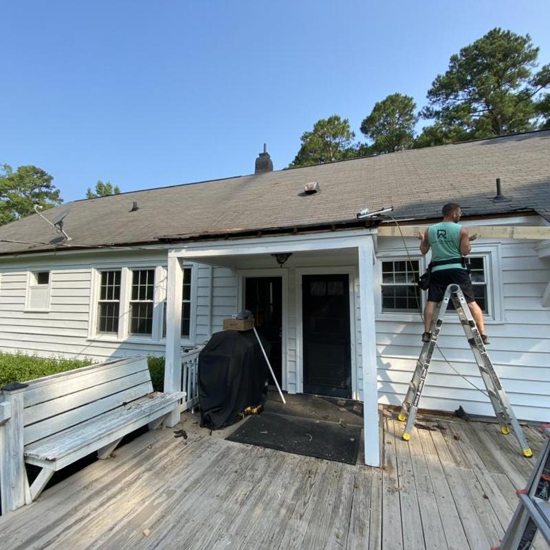 Roof edge removal and fascia repair on white house