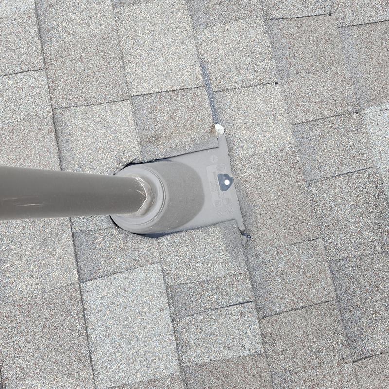 Roof pipe flashing with sealed exposed fasteners