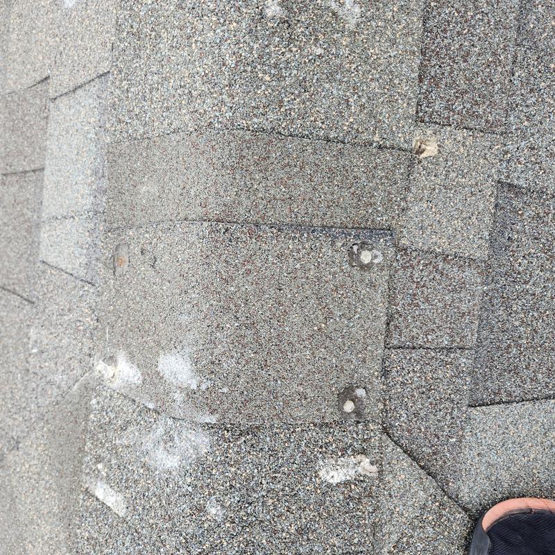 Roof shingles with exposed fasteners and sealed areas