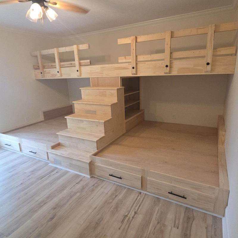 Custom wooden bunk bed with storage drawers and stairs