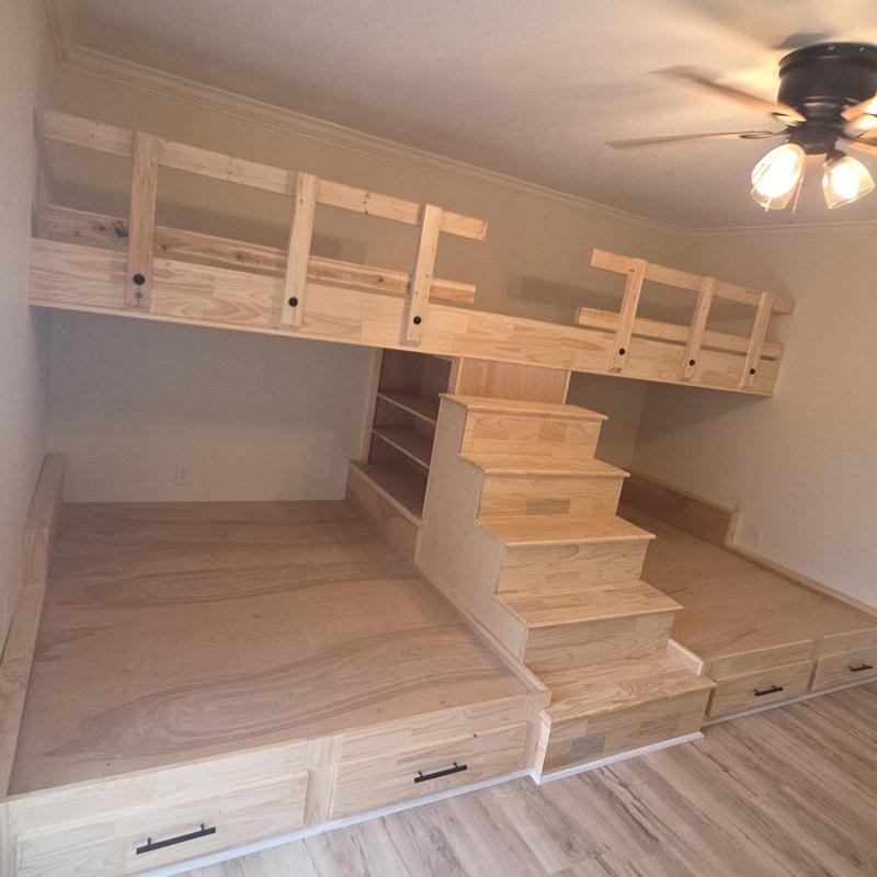 Custom wooden bunk bed with stairs and storage drawers