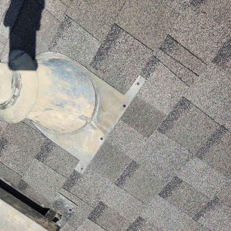 Roof vent flashing with exposed fasteners on shingles