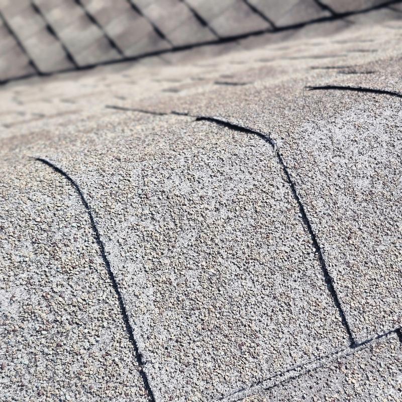 Roof shingles granular loss and wear close-up inspection