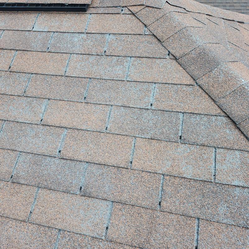 Asphalt shingle roof with missing and damaged shingles Asphalt shingle roof with missing and damaged shingles