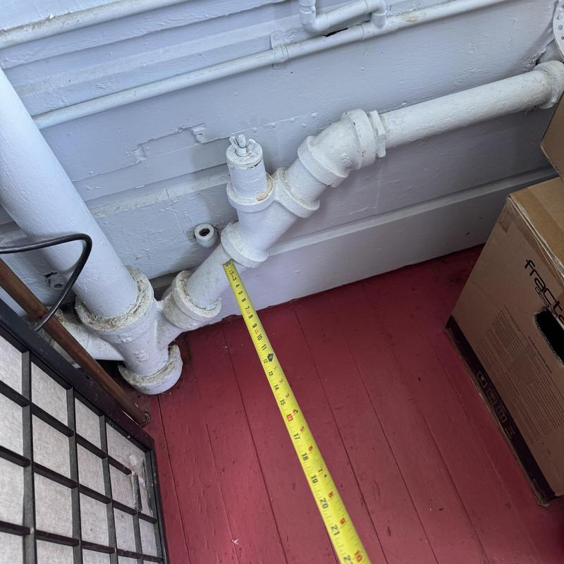 Cast iron drain pipe with measurement tape