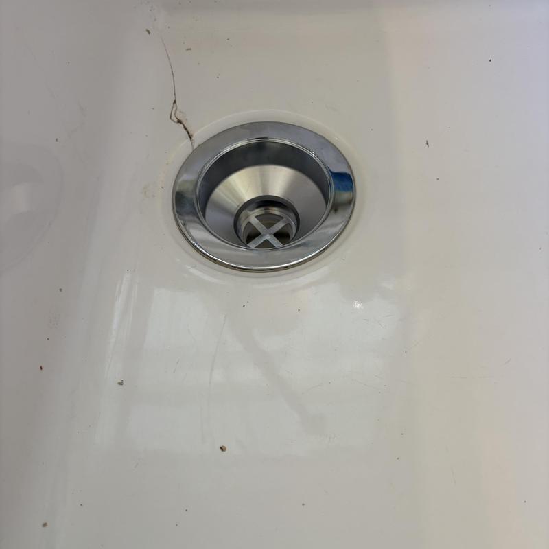 Kitchen sink basket strainer installed in white sink