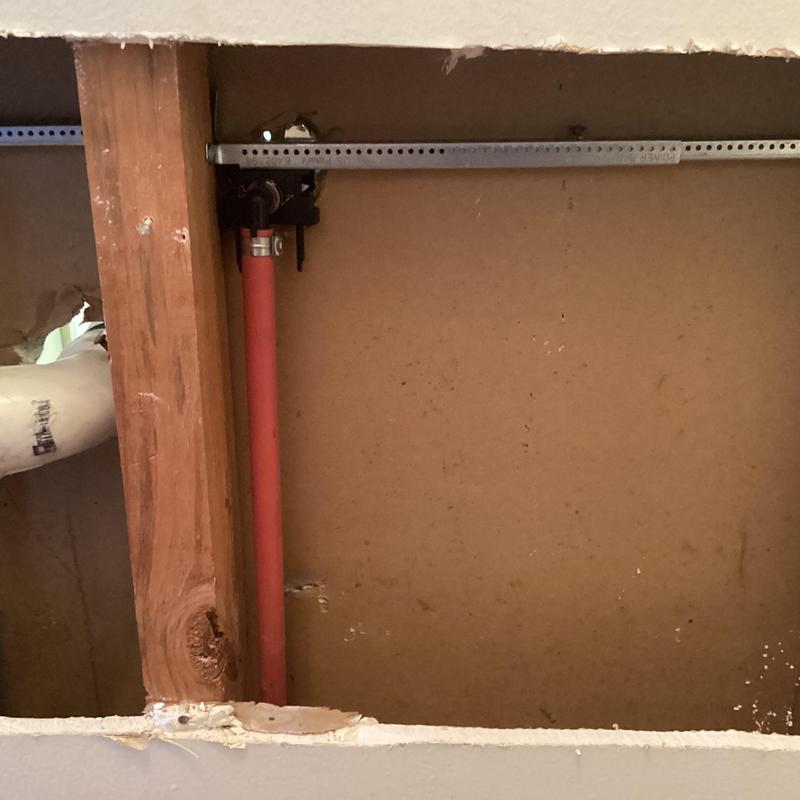 Pex water supply line and cast iron drain behind drywall