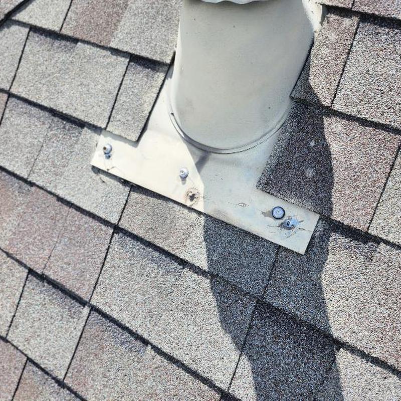 Roof pipe flashing with exposed fasteners on shingles