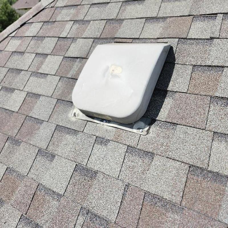Roof vent with dent and exposed fastener on shingles