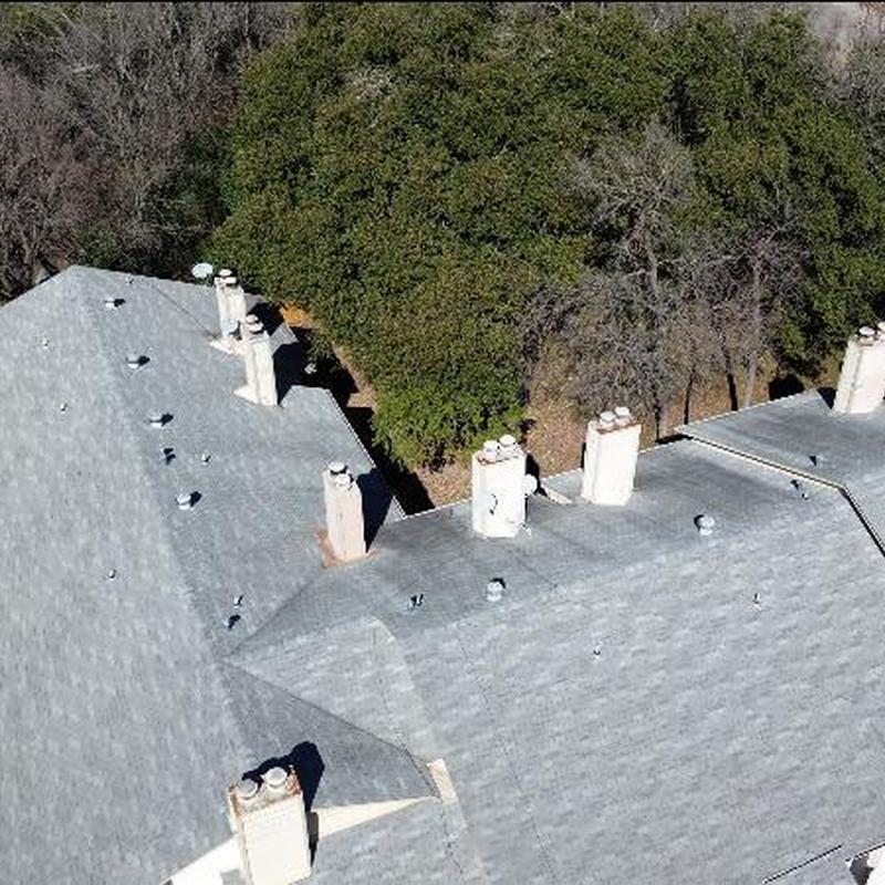 Chimney cricket and rusted chimney chase on rooftop