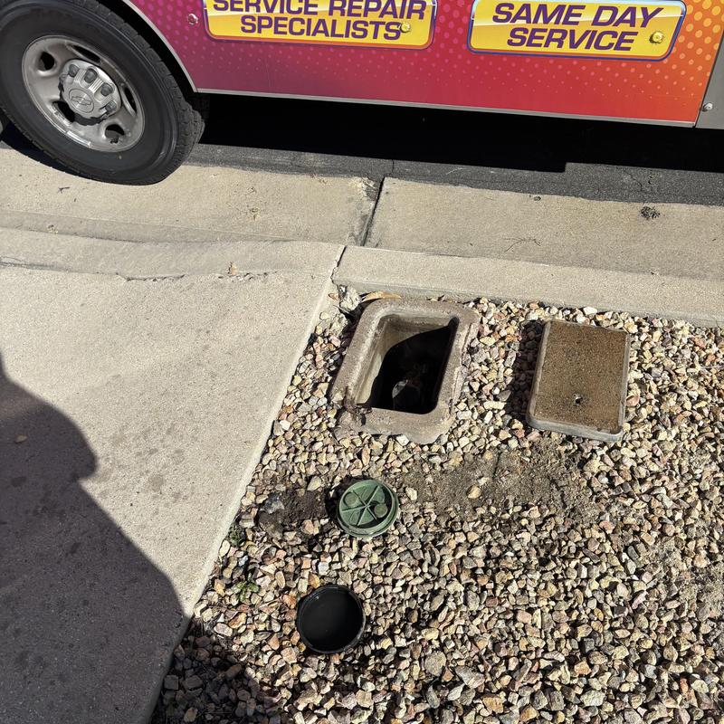 Water main valve access with cover removed outdoors