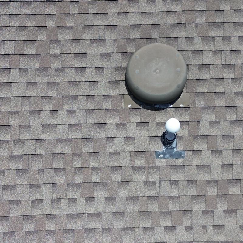 Plastic roof vent on shingled roof panels