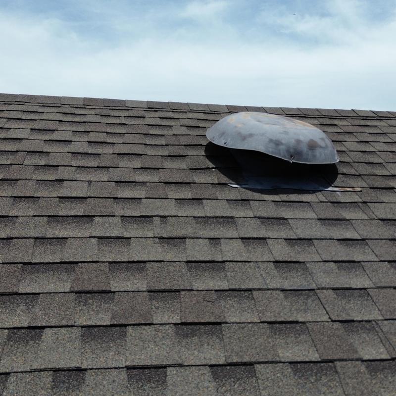 Metal roof vent on asphalt shingle roof