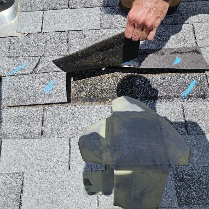Asphalt roof shingles with hail damage markings Asphalt roof shingles with hail damage markings