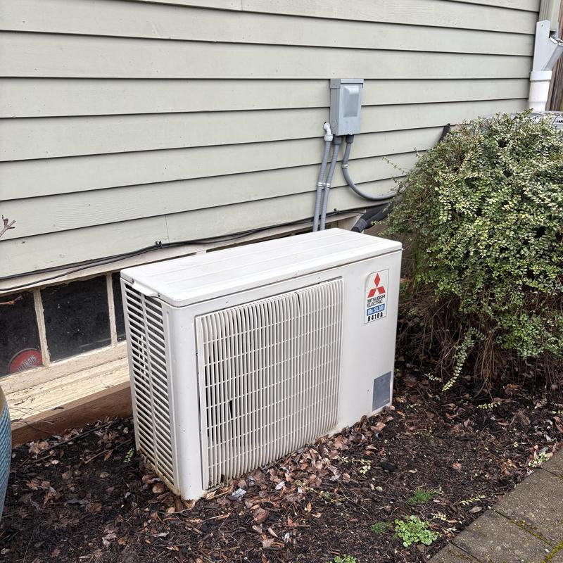 Mitsubishi outdoor mini split unit by house wall Mitsubishi outdoor mini split unit by house wall