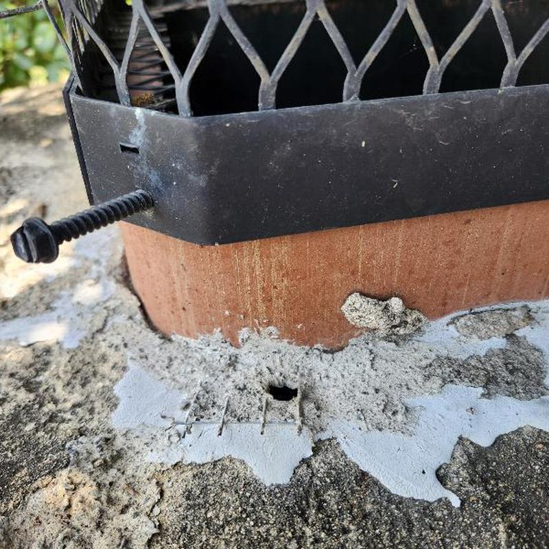 Chimney mortar hole and flue gap sealed with caulk