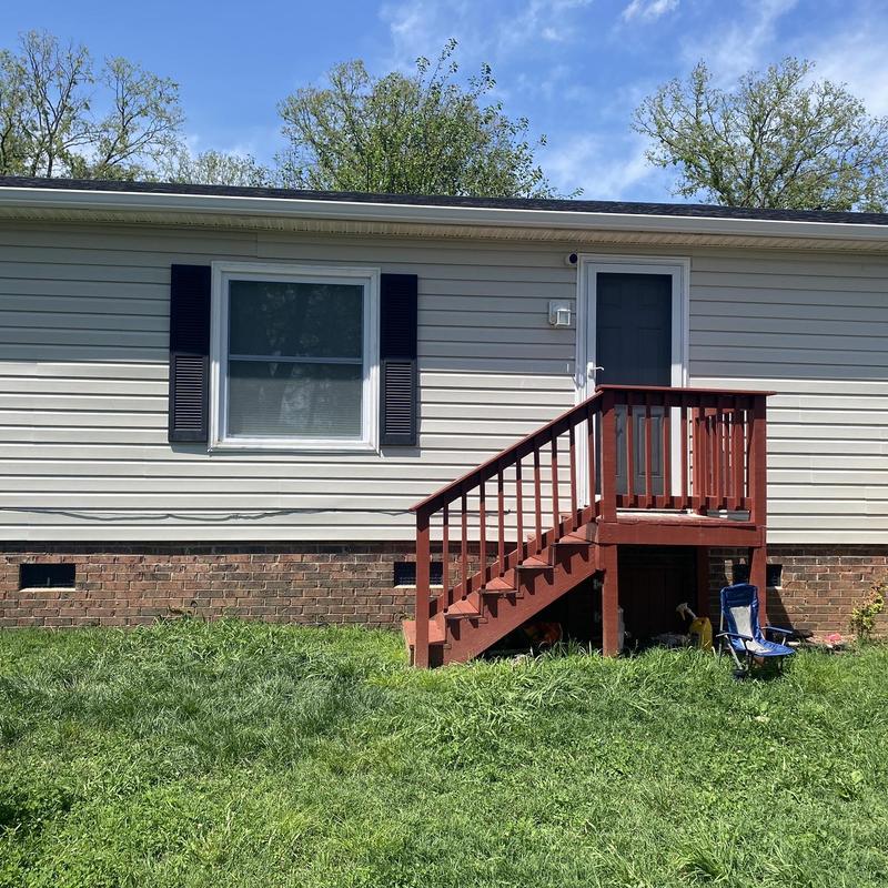 Vinyl siding and black shutters on residential home Vinyl siding and black shutters on residential home