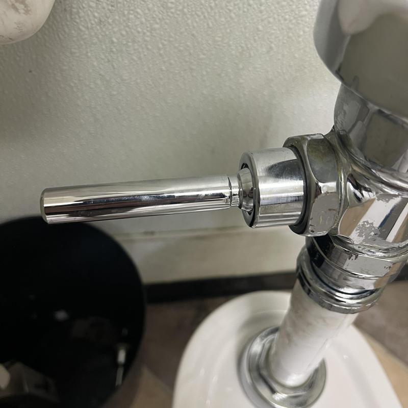 Flush handle on commercial toilet plumbing fixture