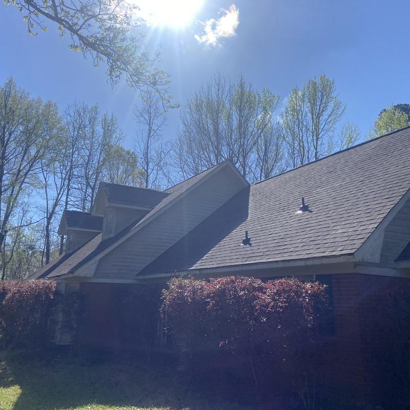 Architectural shingle roof on residential home in sunlight