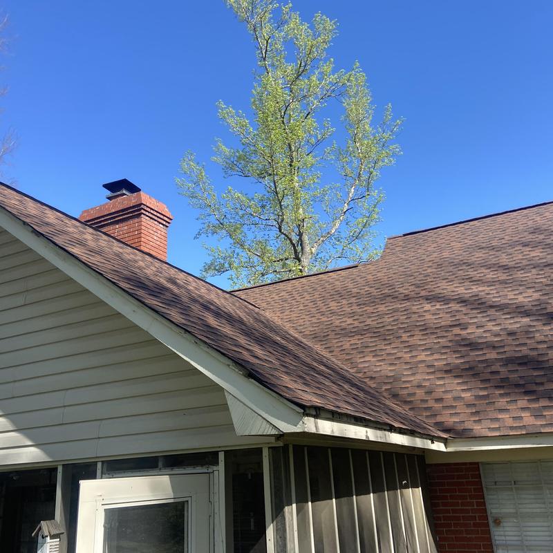 Architectural shingle roof installation with chimney vent