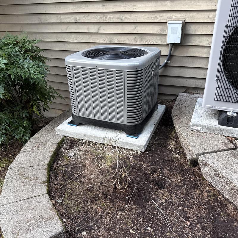 Ruud air conditioner unit on concrete pad outdoors Ruud air conditioner unit on concrete pad outdoors