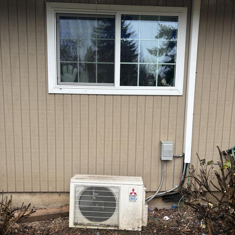 Mitsubishi heat pump unit outside beige siding house Mitsubishi heat pump unit outside beige siding house