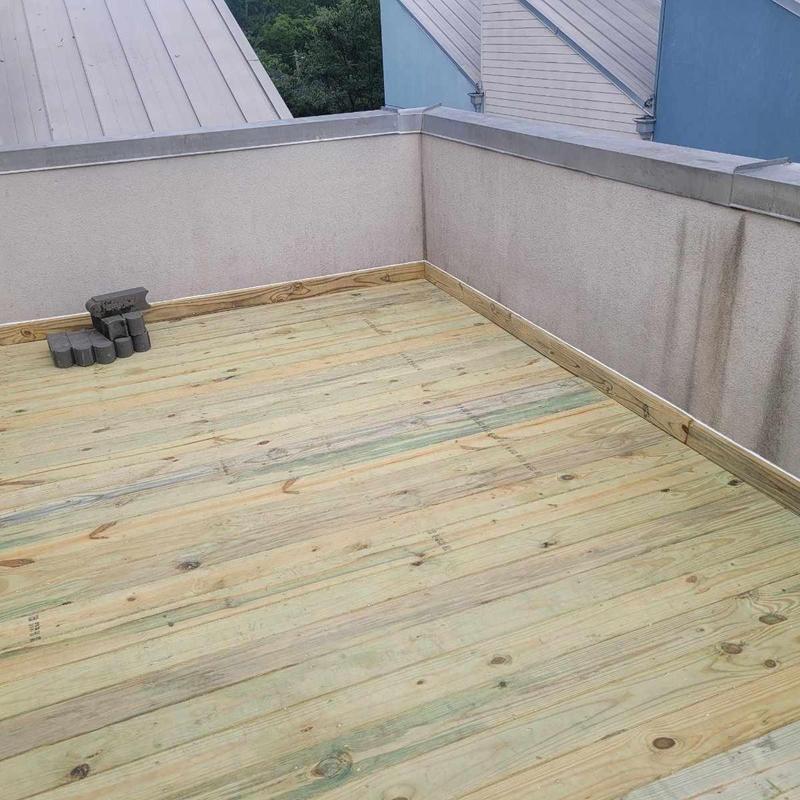 Flat roof wooden deck boards with new coating