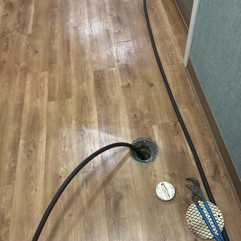 Drain line hydro-jet cleaning with tools on floor Drain line hydro-jet cleaning with tools on floor