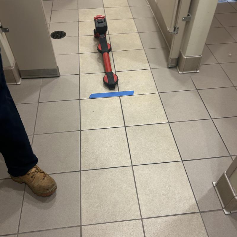 Main line pipe locator on tiled bathroom floor Main line pipe locator on tiled bathroom floor