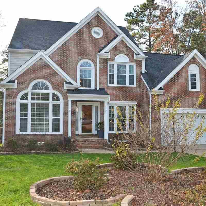 Brick exterior siding and windows on suburban home Brick exterior siding and windows on suburban home