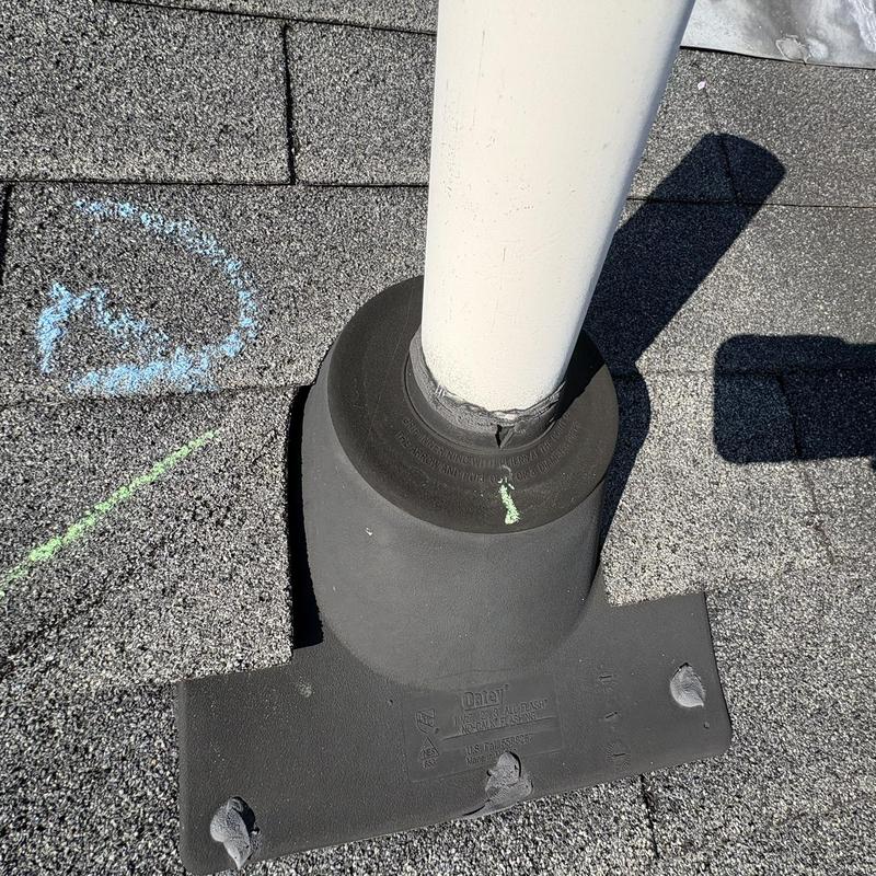 Roof vent pipe flashing with cracked sealant on shingles