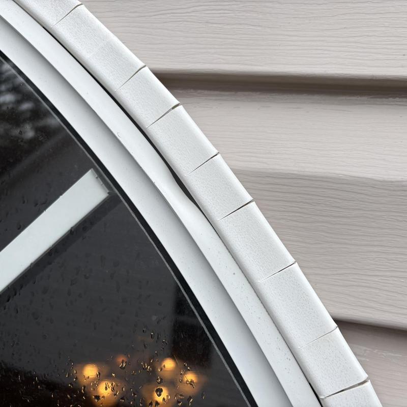 Window frame sealant gaps near siding panel