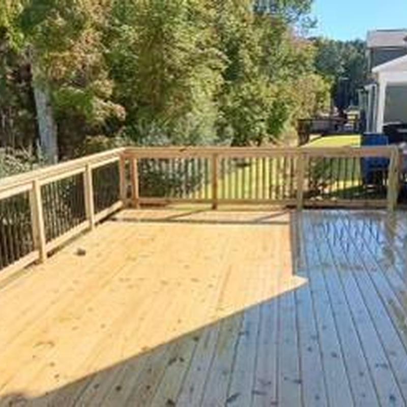 Wood deck with new railing installation in backyard Wood deck with new railing installation in backyard