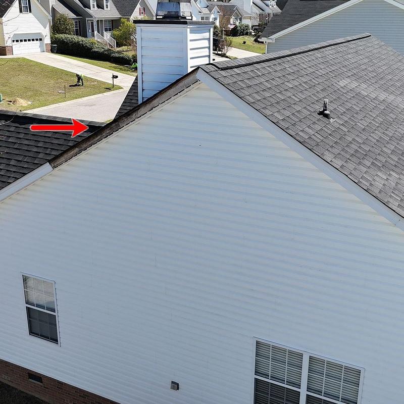 Roof ridge and flashing inspection with red arrow indicator Roof ridge and flashing inspection with red arrow indicator