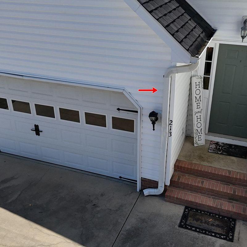 Gutter downspout connection on garage exterior wall Gutter downspout connection on garage exterior wall