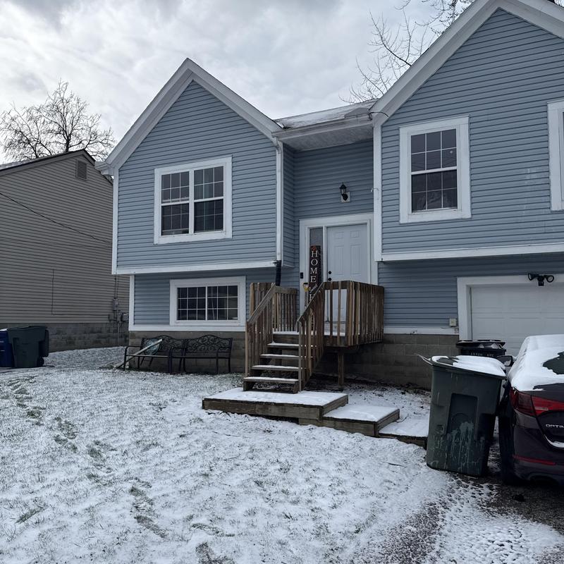 Wooden front stairs with light snow in residential yard Wooden front stairs with light snow in residential yard
