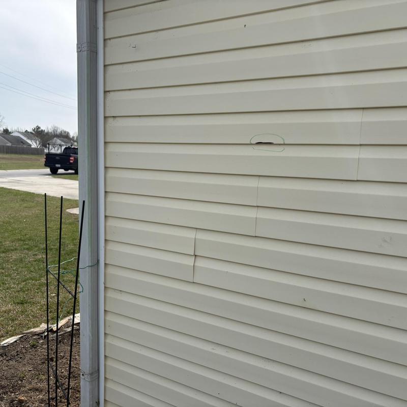 Vinyl siding with hail and wind damage