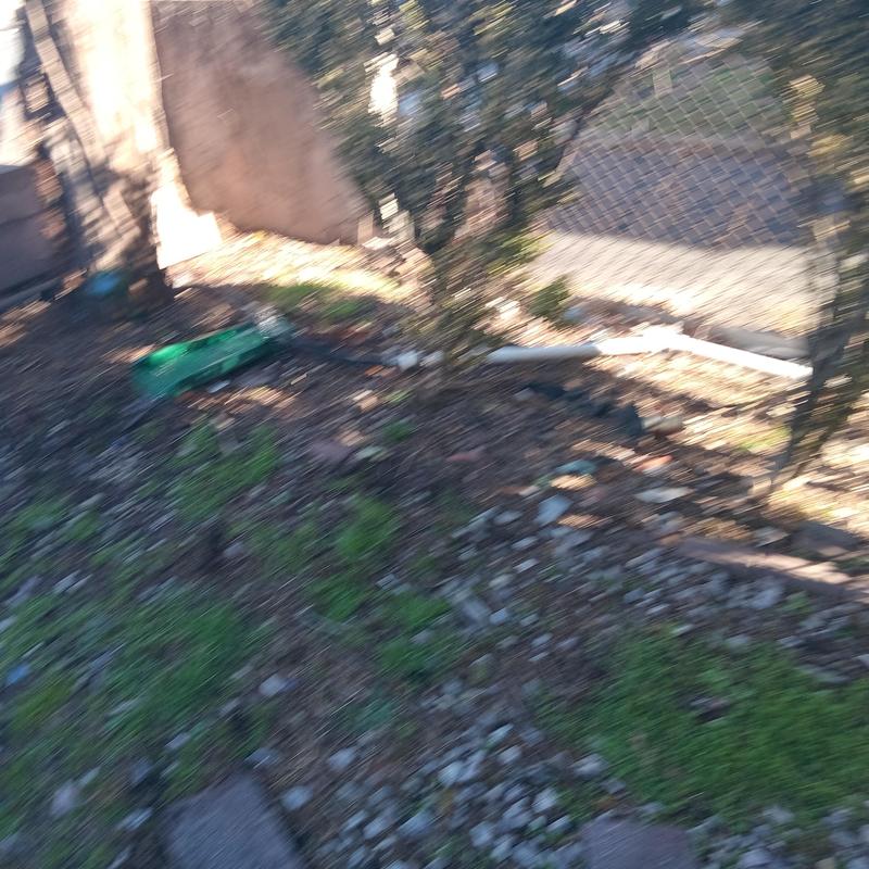 PVC Drain Pipe Outside Yard with Fence Background PVC Drain Pipe Outside Yard with Fence Background