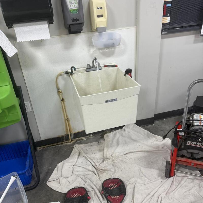 Utility sink drain line with snake tool and running water