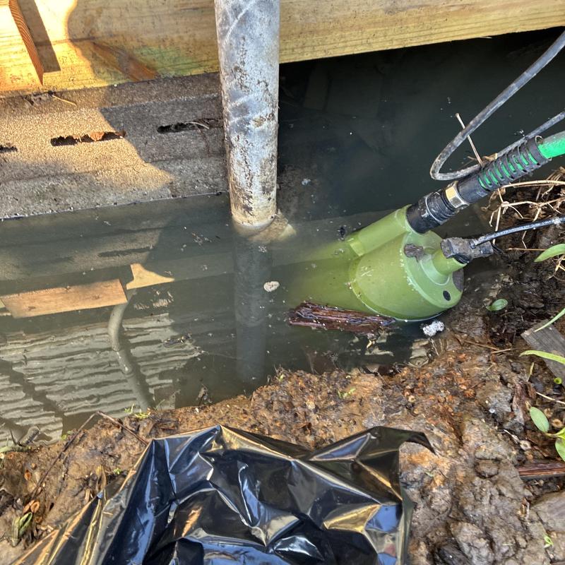 Clean out pipe pumping water from under home