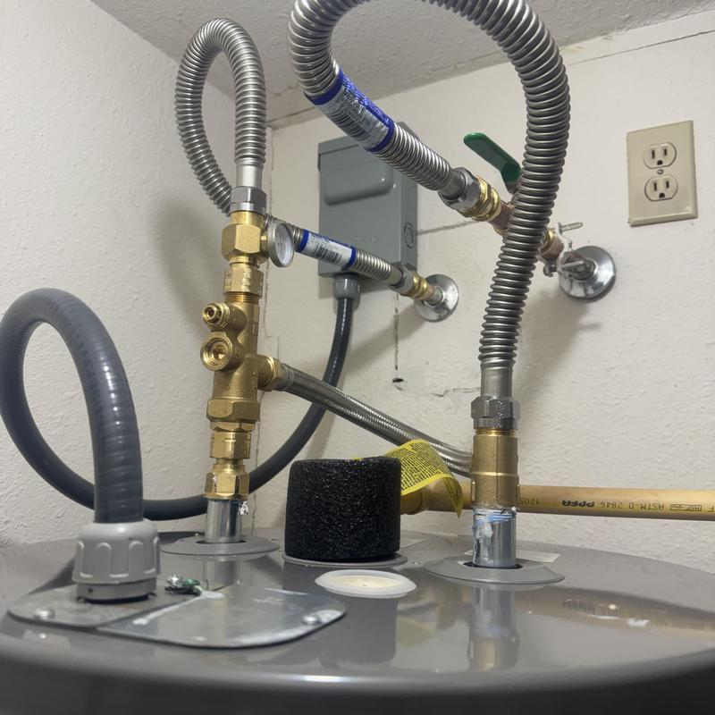 Electric water heater with ball valve and flex lines installed
