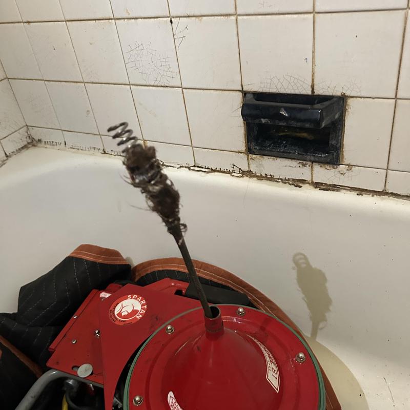 Bathtub drain cleaning machine and clogged hair debris Bathtub drain cleaning machine and clogged hair debris