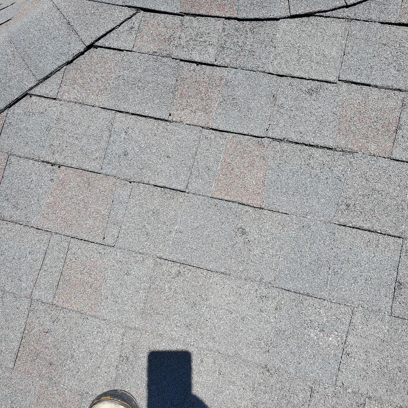 Asphalt shingles with hail damage on roof surface